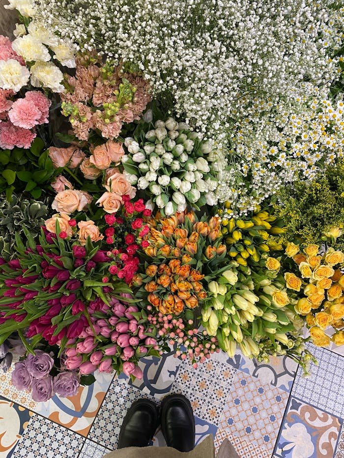 Beautiful assortment of colorful flowers on a patterned floor.