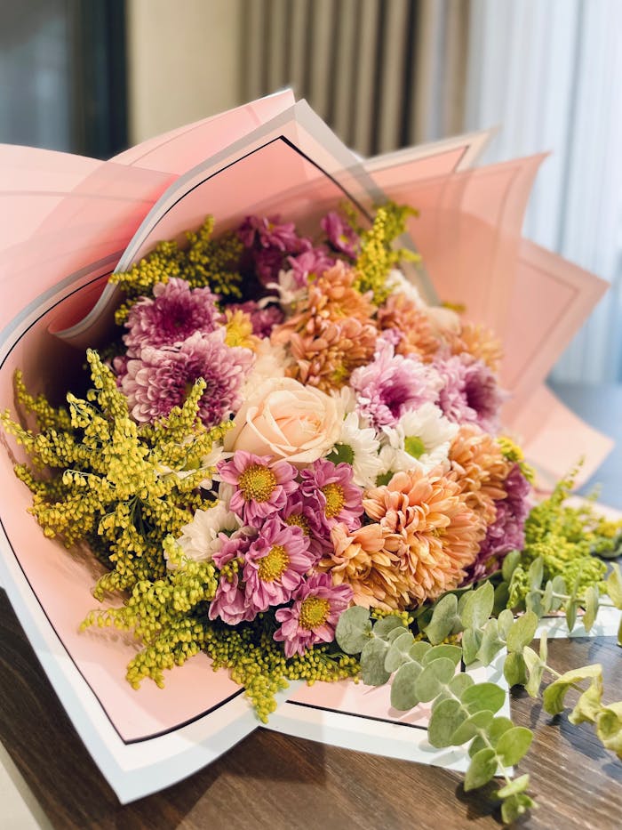Colorful bouquet with chrysanthemums and roses in pastel hues.