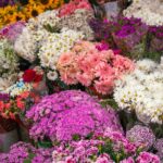 Colorful display of various fresh flower bouquets in a market setting.