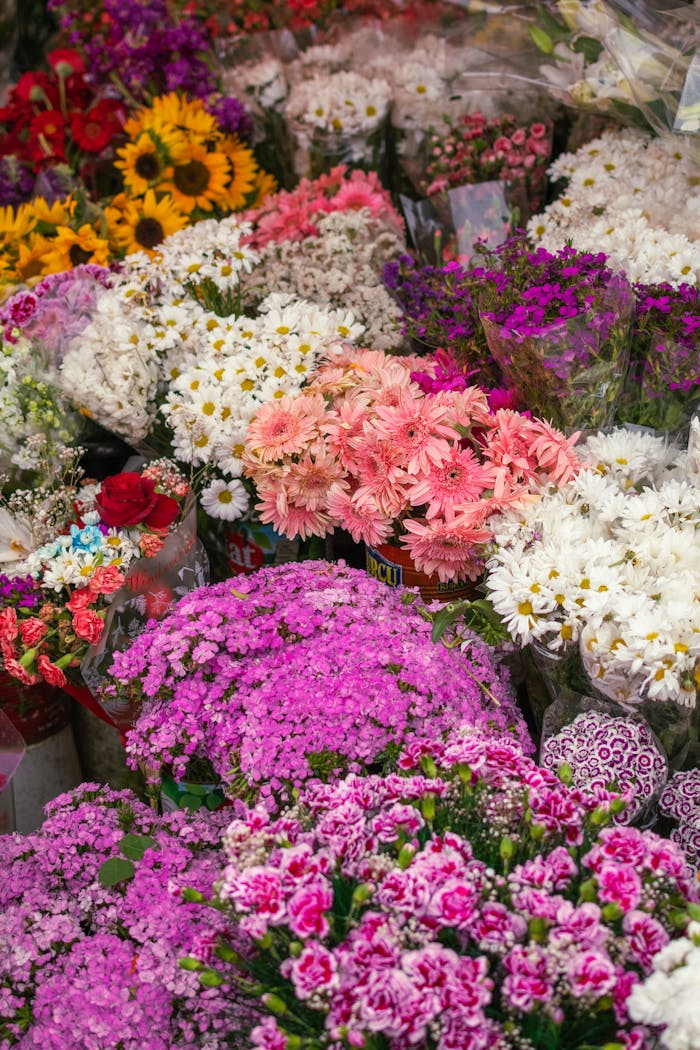 services-01 Colorful display of various fresh flower bouquets in a market setting.